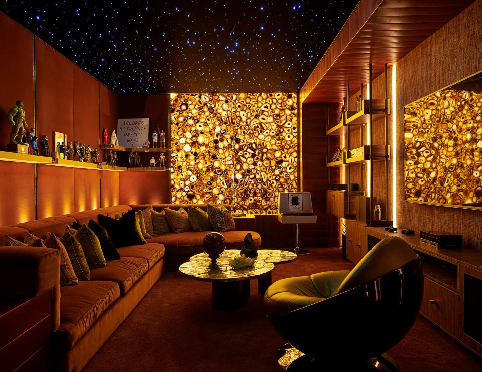 A backlit panel of brown agate semi-precious stone softly illuminates the studio lounge. Erwan Boulloud aluminum cocktail table; vintage Ricardo Fasanello chair.