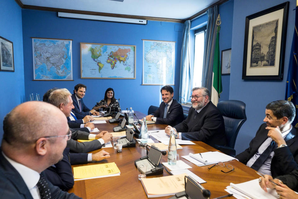 Italian Premier Giuseppe Conte, third from right, sits next to COPASIR (Italian parliamentary intelligence committee) head Raffaele Volpi, second from right, before testifying behind closed doors to the committee about a meeting between United States Attorney General William Barr and Italian intelligence, in Rome, Wednesday, Oct. 23, 2019. Media reports have indicated that Conte authorized the contacts -- one in August and one in September -- in violation of protocol. (Angelo Carconi/ANSA via AP)