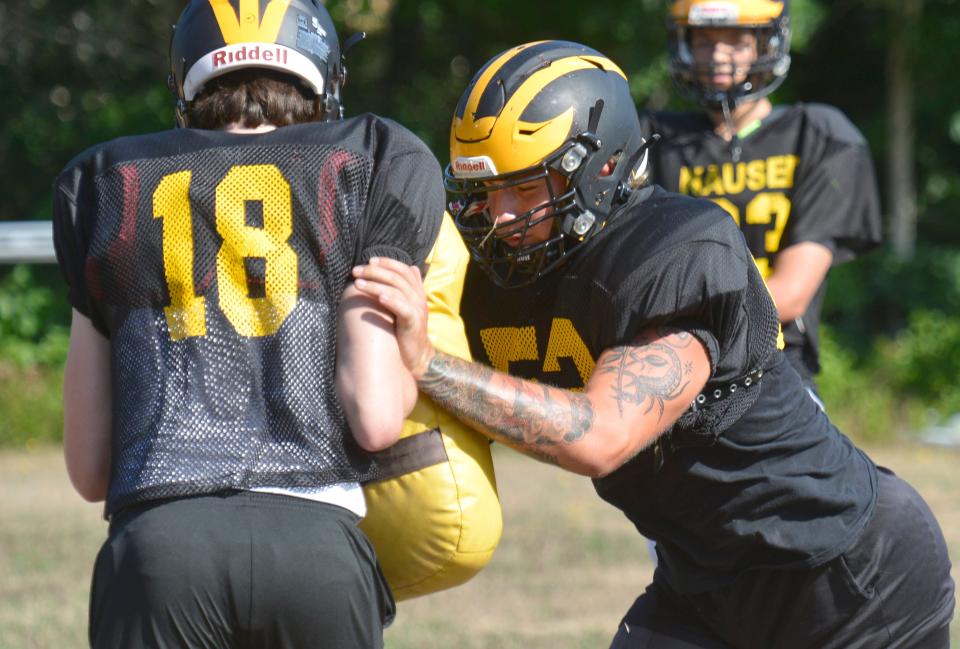 NORTH EASTHAM -- 08/29/22 -- Raven Bennett, right, works through a practice drill Monday morning. Nauset Regional High School football is back in action. A practice was held Monday morning.  To see more photos, go to  www.capecodtimes.com/news/photo-galleries. Merrily Cassidy/Cape Cod Times