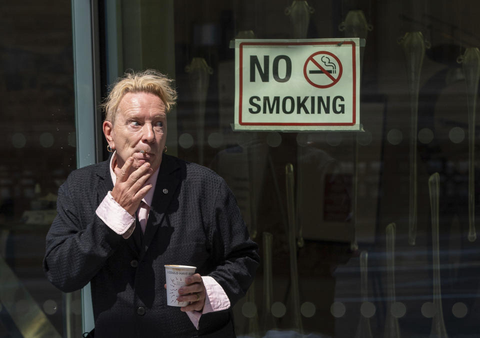 John Lydon, also known as Johnny Rotten, outside the Hight Court Rolls Building in London, where he is giving evidence in a hearing between two former Sex Pistols band members and the band frontman over the use of their songs in a television series, Wednesday July 21, 2021. Drummer Paul Cook and the band's former guitarist, Steve Jones, are suing the Pistols' former lead singer to allow their songs to be used in a TV series. (Dominic Lipinski/PA via AP)