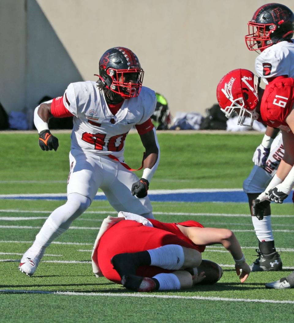 Del City's Ricklan Holmes celebrates a quarterback sack at a semi-final playoff game as Del City plays Claremore on Nov 24, 2023; in Noble, Oklahoma, USA; at Noble High School. Mandatory Credit: Steve Sisney-The Oklahoman