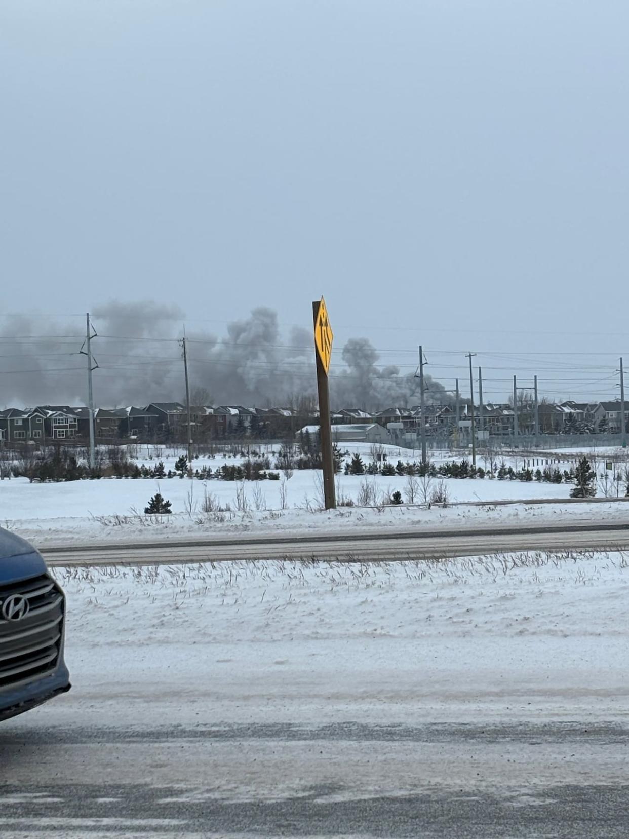 Calls about a fire in the southeastern community of Auburn Bay started coming in around 4 p.m. Thursday. When fire crews arrived on the scene, one house was fully engulfed in flames. (Submitted by Phil Lansdown - image credit)