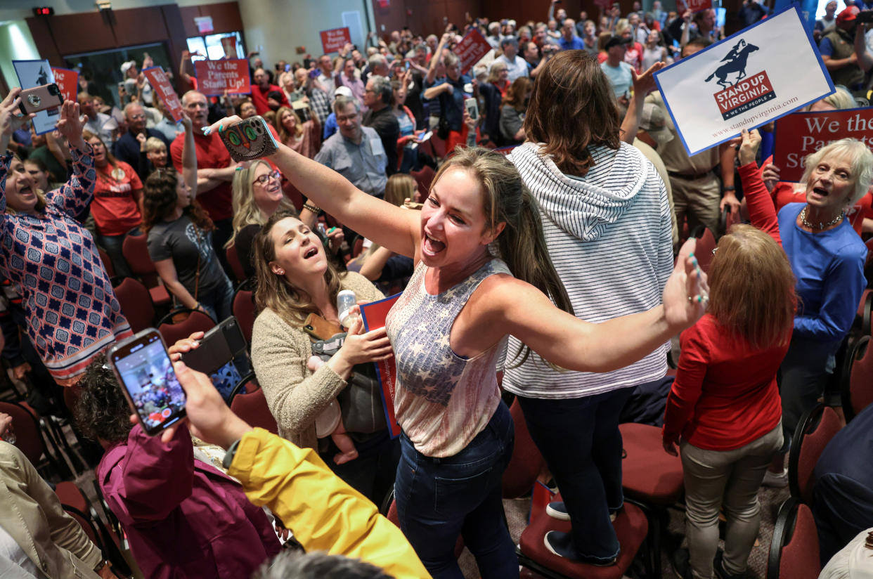 Image: Elicia Brand leads a crowd of parents and community members singing the Star Spangled Banner at a Loudoun County School Board meeting in Va., on June 22, 2021. Local school boards in the state criticized critical race theory teachings. (Evelyn Hockstein / Reuters file)