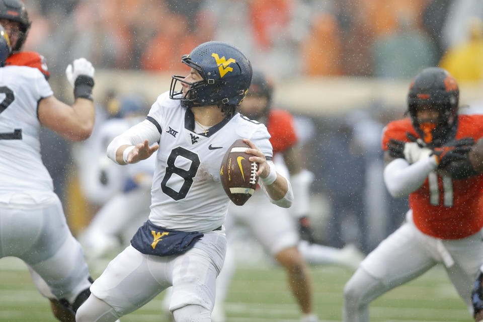 Nov 26, 2022; Stillwater, Oklahoma, USA; West Virginia Mountaineers quarterback Nicco Marchiol (8) drops back to pass during a college football game between Oklahoma State and West Virginia at Boone Pickens Stadium. Bryan Terry-USA TODAY Sports