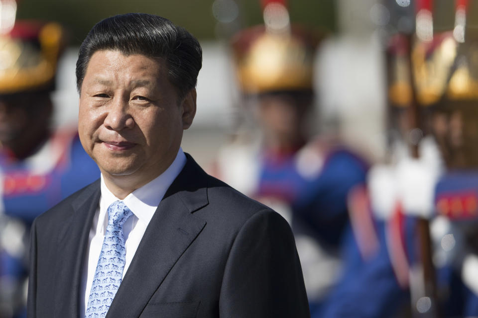 China's President Xi Jinping walks past an honor guard as he arrives for a meeting with Brazil's President Dilma Rousseff at the Planalto Presidential Palace, in Brasilia, Brazil, Thursday, July 17, 2014. (AP Photo/Felipe Dana)