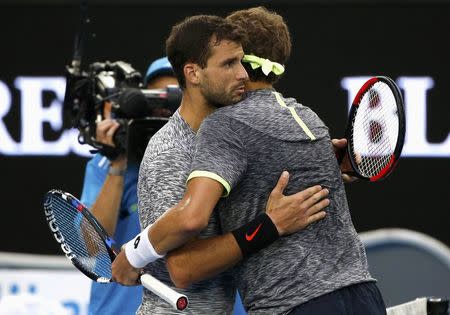 Tennis - Australian Open - Melbourne Park, Melbourne, Australia - 23/1/17 Bulgaria's Grigor Dimitrov consoles Uzbekistan's Denis Istomin after winning their Men's singles fourth round match. REUTERS/Issei Kato