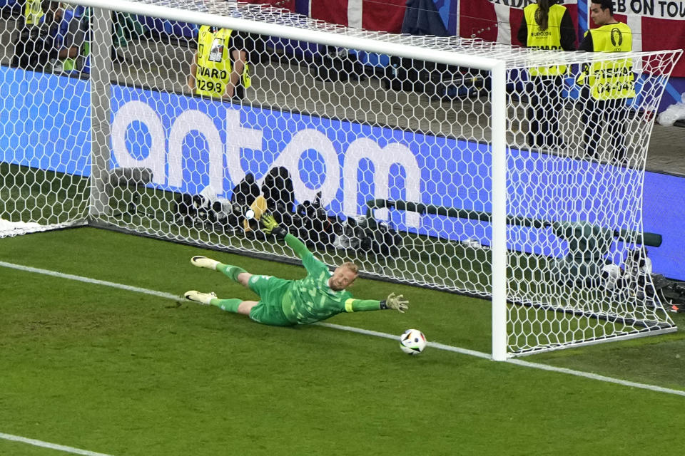 Denmark's goalkeeper Kasper Schmeichel dives but fails to save the goal from Germany's Kai Havertz during a round of sixteen match between Germany and Denmark at the Euro 2024 soccer tournament in Dortmund, Germany, Saturday, June 29, 2024. (AP Photo/Hassan Ammar)