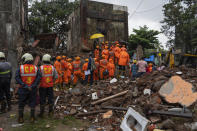 Rescuers look for survivors in the debris of a four-story residential building that collapsed in Mumbai, India, Tuesday, June 28, 2022. At least three people died and more were injured after the building collapsed late Monday night. (AP Photo/Rafiq Maqbool)