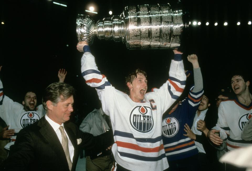 EDMONTON, AB - MAY 19: Wayne Gretzky #99 of the Edmonton Oilers holds the Stanley Cup over his head after the Oilers defeated the New York Islanders in Game 5 of the 1984 NHL Stanley Cup Finals on May 19, 1984 at the Northlands Coliseum in Edmonton, Alberta, Canada. (Photo by Focus On Sport/Getty Images)