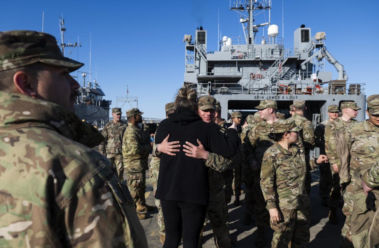 A military spouse hugs a U.S. soldier at Joint Base Langley-Eustis ahead of deployment on March 12, 2024. <a href="https://www.gettyimages.com/detail/news-photo/samantha-maleck-hugs-her-husband-chief-warrant-officer-news-photo/2071882063?adppopup=true" rel="nofollow noopener" target="_blank" data-ylk="slk:Roberto Schmidt/AFP via Getty Images;elm:context_link;itc:0;sec:content-canvas" class="link ">Roberto Schmidt/AFP via Getty Images</a>