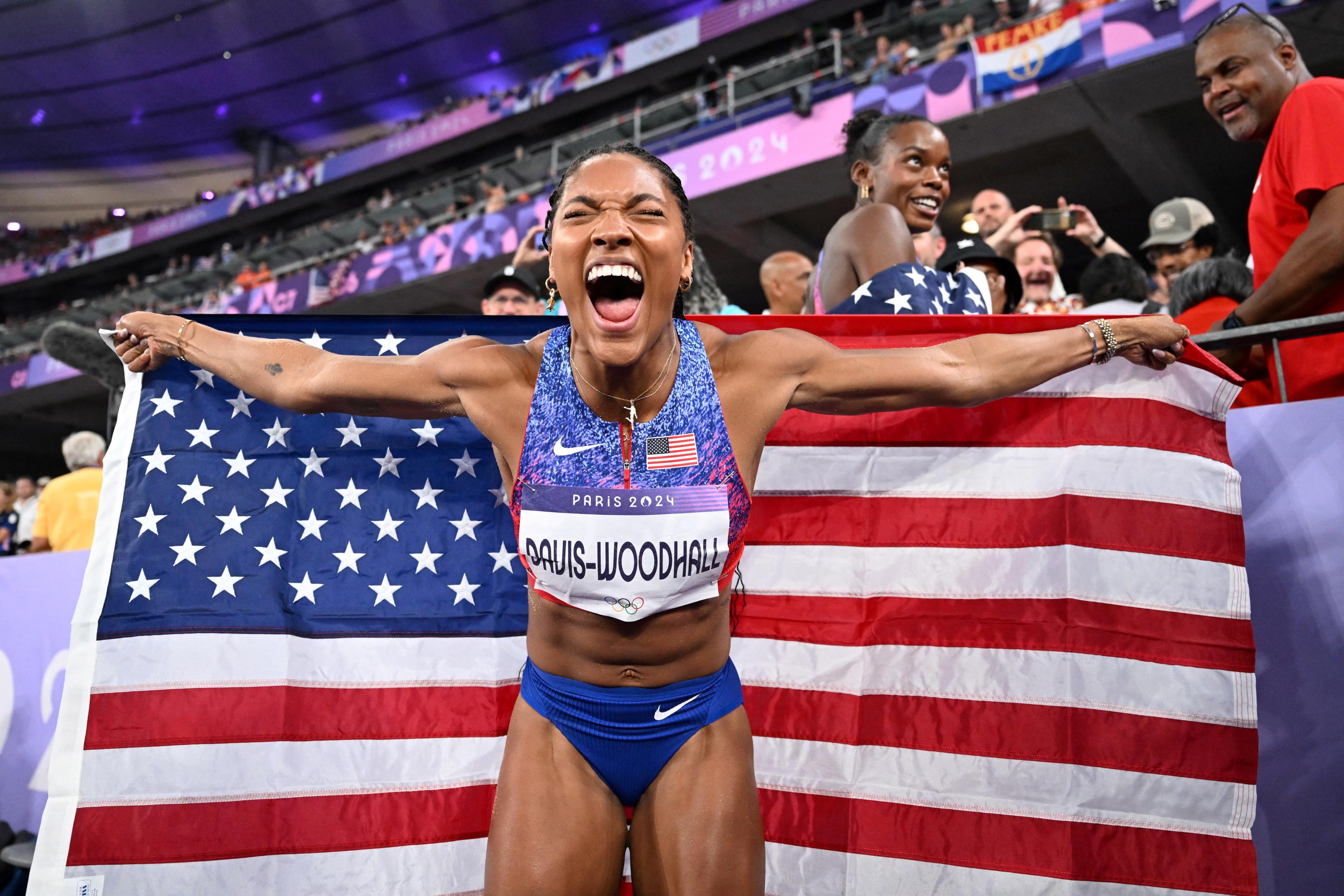 Gold medallist US' Tara Davis-Woodhall celebrates winning the women's long jump final of the athletics event at the Paris 2024 Olympic Games at Stade de France in Saint-Denis, north of Paris, on August 8, 2024. (Photo by Kirill Kudryavtsev/AFP/Getty Images)