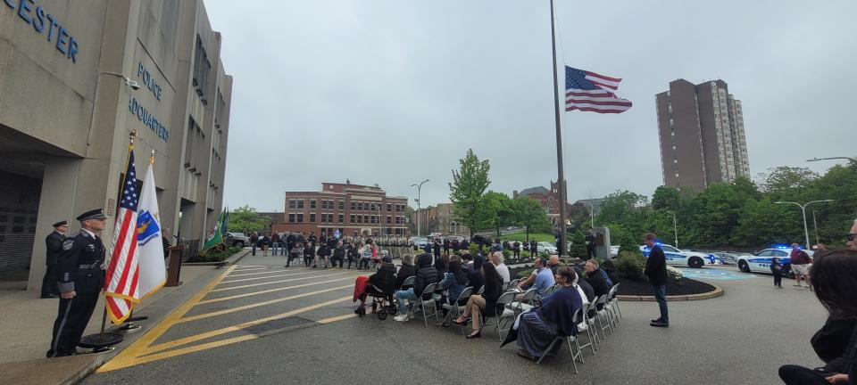 Family members of police officers who died over the past year listen as speakers address them at the annual Worcester Police Memorial Sunday event.