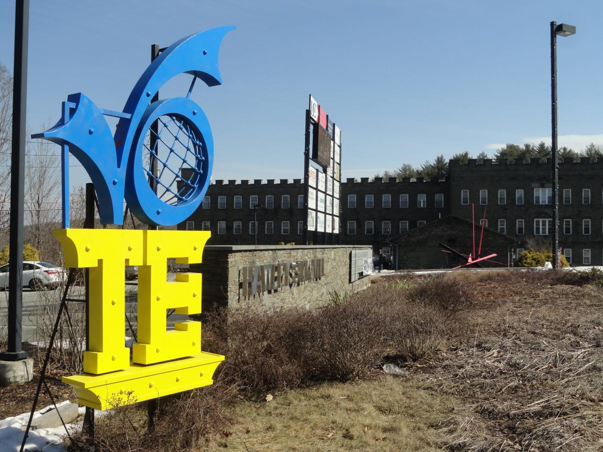 Christopher Hughes' 12 foot "VOTE" sculpture stands near Route 6 by the Hawley Silk Mill sign. The steel sculpture was unveiled in 2018 to encourage Americans to vote and support their democracy. In March 2022, Hughes repainted it in the colors of the Ukranian flag to support the Ukranian people enduring the current war with Russia.