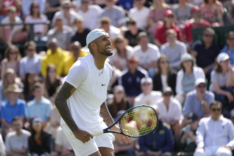 Australia's Nick Kyrgios celebrates retaining a service game during the singles tennis match against Britain's Paul Jubb on day two of the Wimbledon tennis championships in London, Tuesday, June 28, 2022. (AP Photo/Kirsty Wigglesworth)