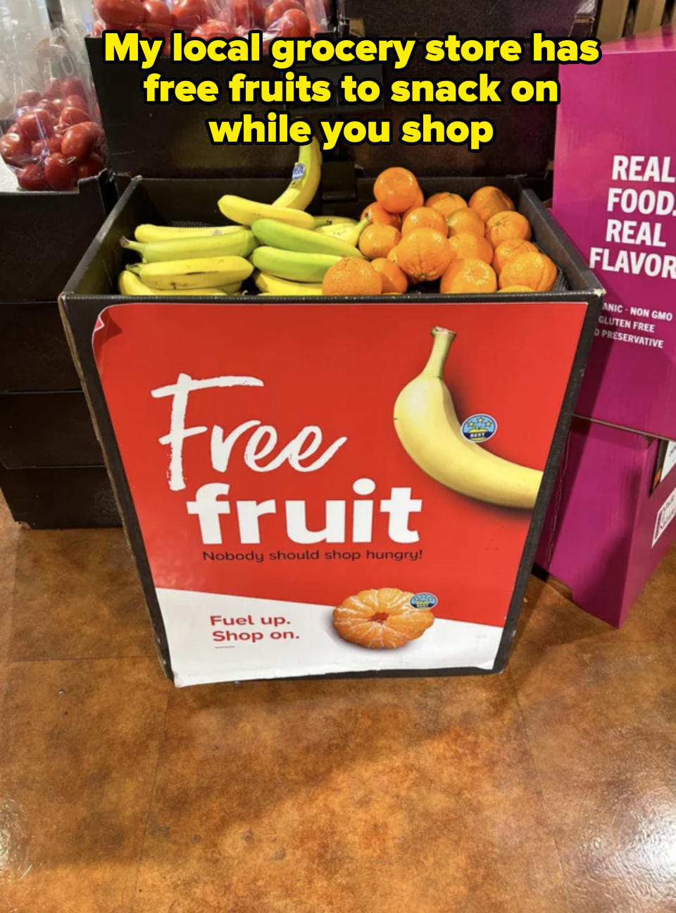 Sign at a store offering 'Free fruit' with the text 'Nobody should shop hungry! Fuel up. Shop on.' Bananas and oranges are pictured