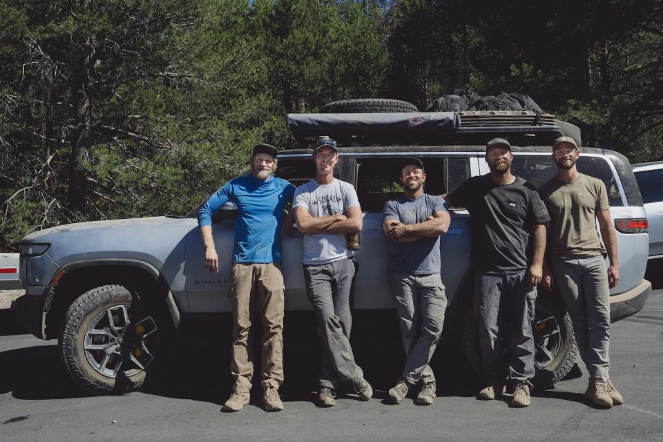 Rivian's development drivers pose next to the R1S that completed the Rubicon Trail