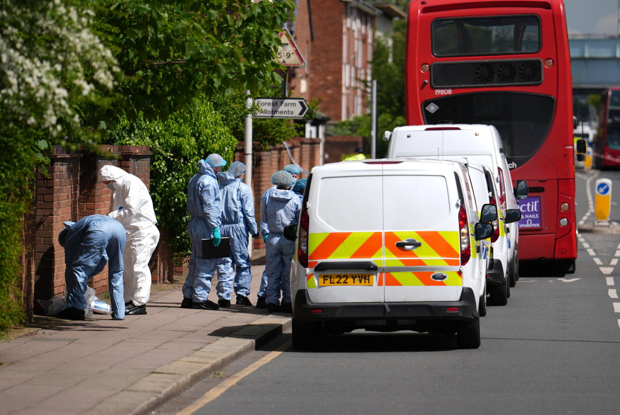 Forensic investigators in Hainault after a 13-year-old boy died after being stabbed. (PA)