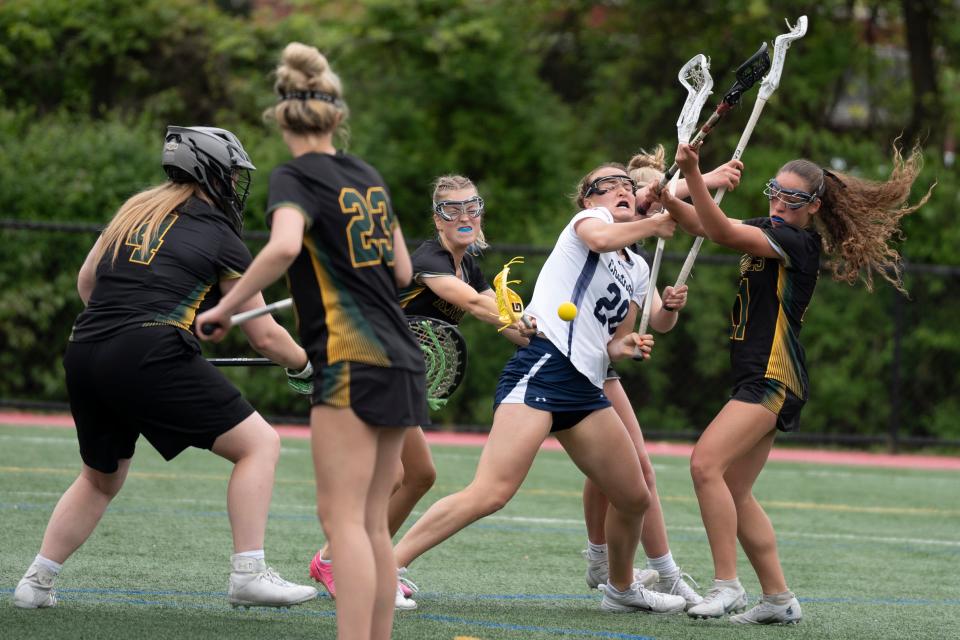 May 4, 2024; Chatham, NJ, USA; Morris Knolls vs.Chatham in a Morris County Tournament girls lacrosse quarterfinal at Haas Field. (Center) C #28 Addison Barrett and (right) MK #11 Lucia Nash battle for the ball.