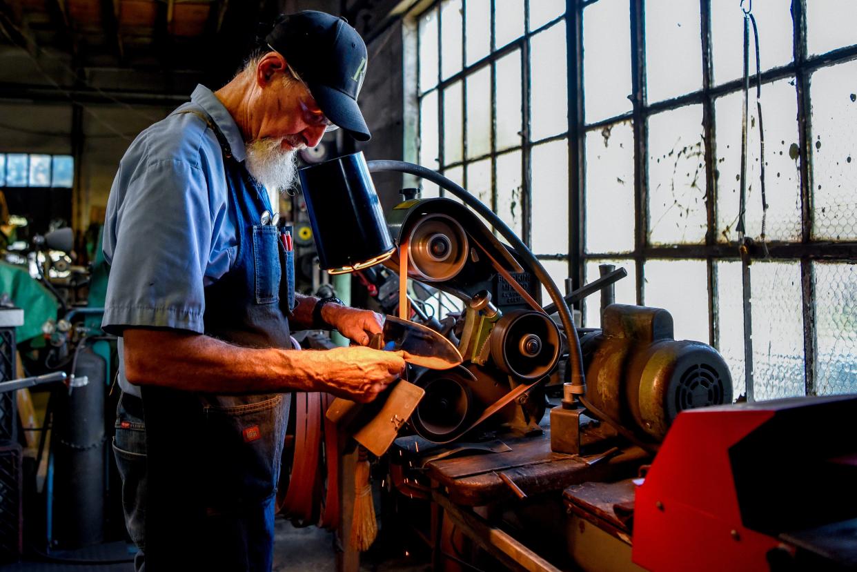 Dave Feinberg, the owner of Cutter's Edge in Clifton recently removed a sign from his store window that inflamed social media. The sign read "Speak English or Pay $10 Extra." Feinerg demonstrates a knife sharpening on Tuesday September 8, 2020. 