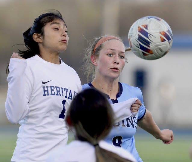 Bartlesville High's Millie Butler, right, contends with a Heritage (Ark.) player for ball control during action on March 28, 2023, at Custer Stadium.