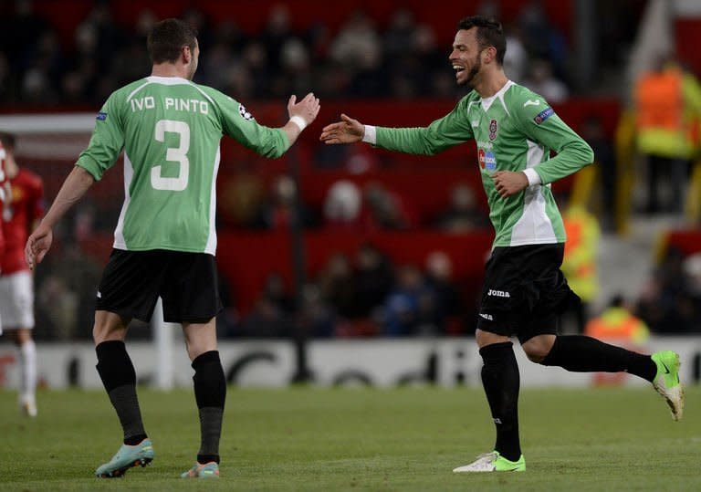 Cluj midfielder Luis Alberto (R) celebrates with defender Ivo Pinto after scoring in the UEFA Champions League Group H match against Manchester United at Old Trafford. Alberto scored the only goal as Cluj secured a 1-0 win, but they were still eliminated from the Champions League