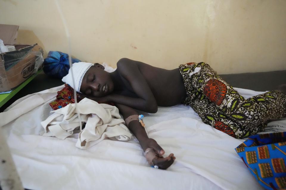 A victim of St. Francis Catholic Church attack lies on a bed at St Louis Catholic Hospital in Owo Nigeria, Monday, June 6, 2022. Lawmakers in southwestern Nigeria say more than 50 people are feared dead after gunmen opened fire and detonated explosives at a church. Ogunmolasuyi Oluwole with the Ondo State House of Assembly said the gunmen targeted the St Francis Catholic Church in Ondo state on Sunday morning just as the worshippers gathered for the weekly Mass. (AP Photo/Sunday Alamba)