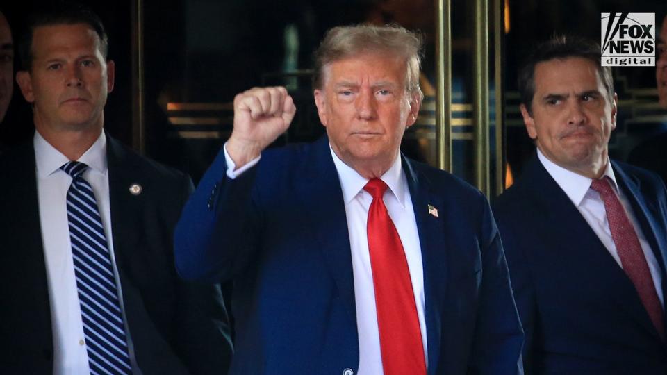 Former President Trump with right fist raised, leaving Trump Tower