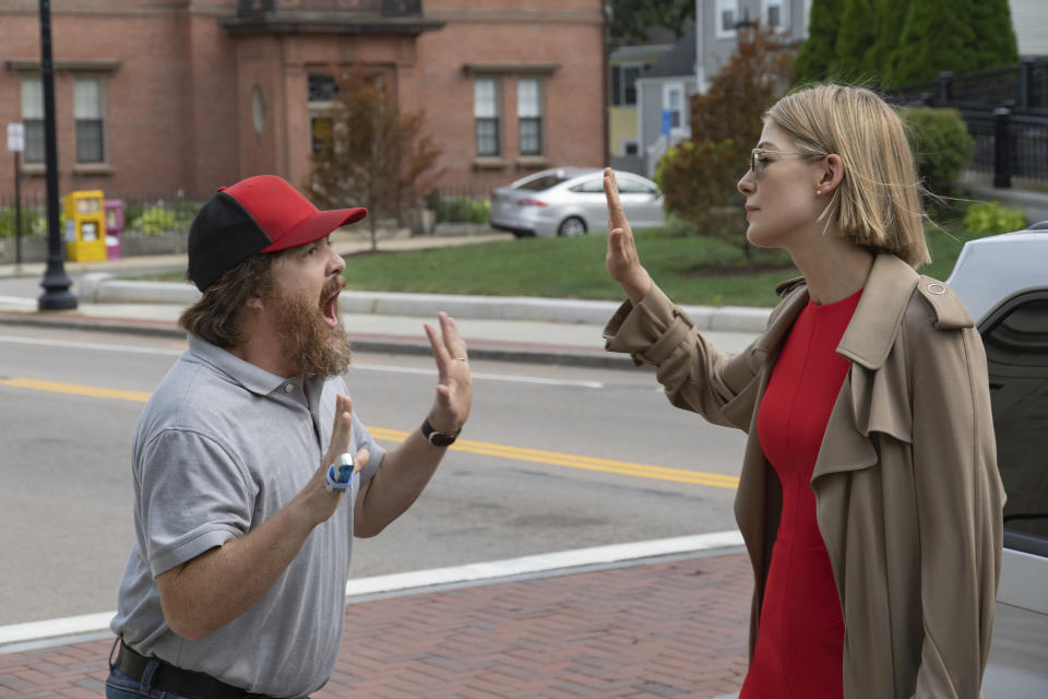 This image released by Netflix shows Macon Blair, left, and Rosamund Pike in a scene from "I Care A Lot." (Seacia Pavao/Netflix via AP)