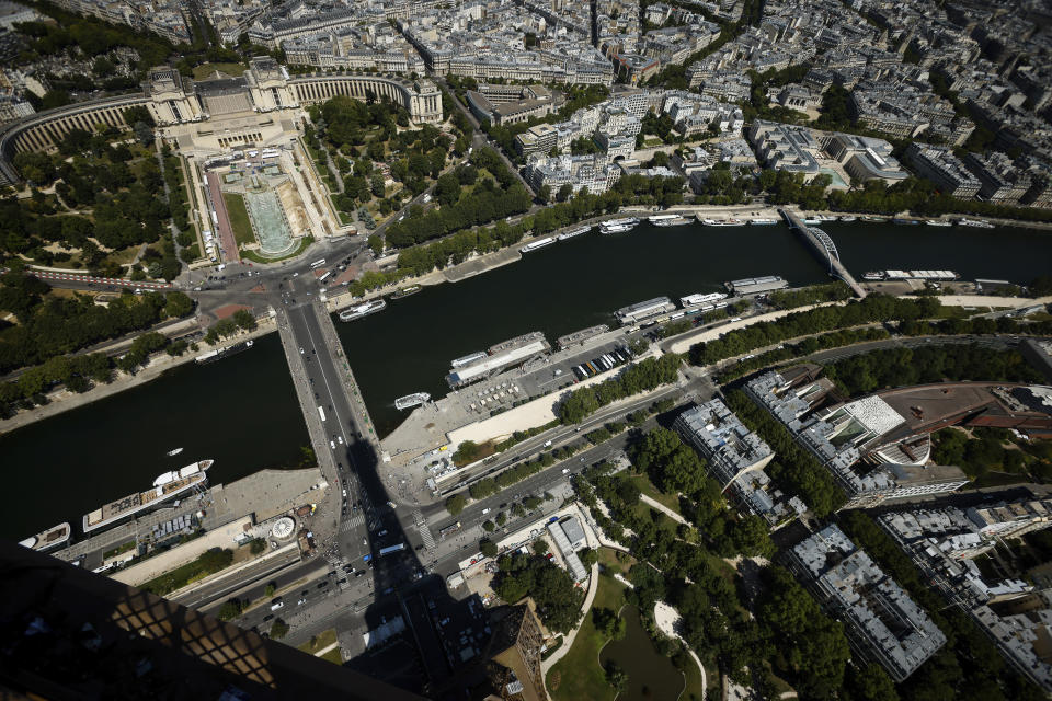 The Eiffel Tower casts its shadow on the Iena bridge, crossing the Seine river and leading to the Trocadero monument Tuesday, July 11, 2023 in Paris. In 2024, the Trocadero will offer a viewing platform for spectators for the triathlon, para triathlon, road cycling, athletics (marathon and 20km race walk) and swimming (10km marathon swimming) events. (AP Photo/Thomas Padilla, File)