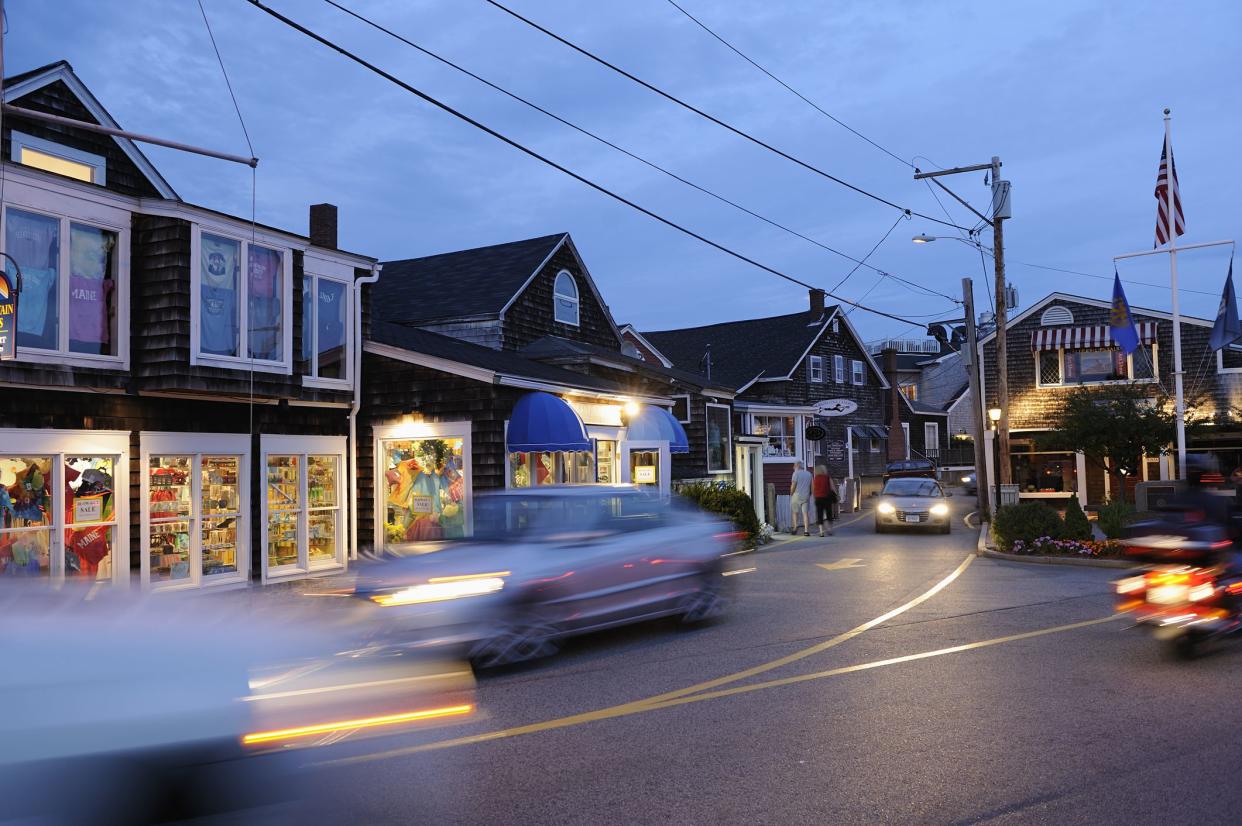 Ogunquit, United States-September 2010: Traffic at sunset in the street of Ogunquit (Perkins Cove area) where you can find shopping stores and restaurant.