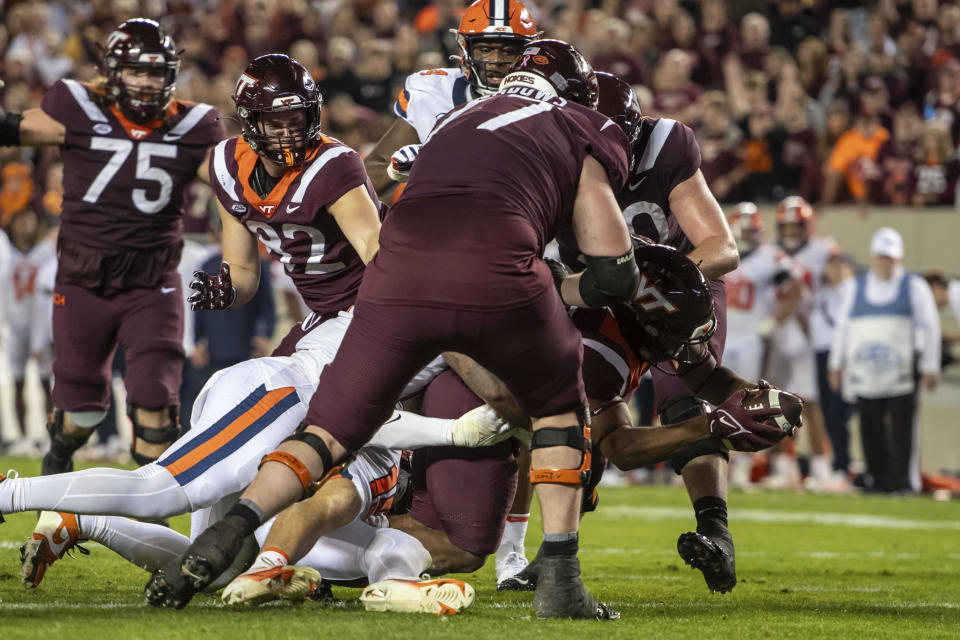 Virginia Tech's Bhayshul Tuten (33) carries the ball for a touchdown against Syracuse during the first half of an NCAA college football game Thursday, Oct. 26, 2023, in Blacksburg, Va. (AP Photo/Robert Simmons)