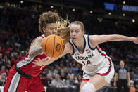 UConn forward Dorka Juhasz (14) and Ohio State guard Rikki Harris battle for a loose ball during the first half of a Sweet 16 college basketball game of the NCAA tournament, Saturday, March 25, 2023, in Seattle. (AP Photo/Stephen Brashear)