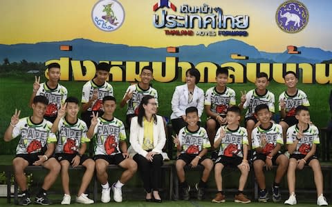 The Twelve Thai boys and their football coach, rescued from a flooded cave after being trapped, attend a press conference in Chiang Rai on July 18, 2018, - Credit: AFP