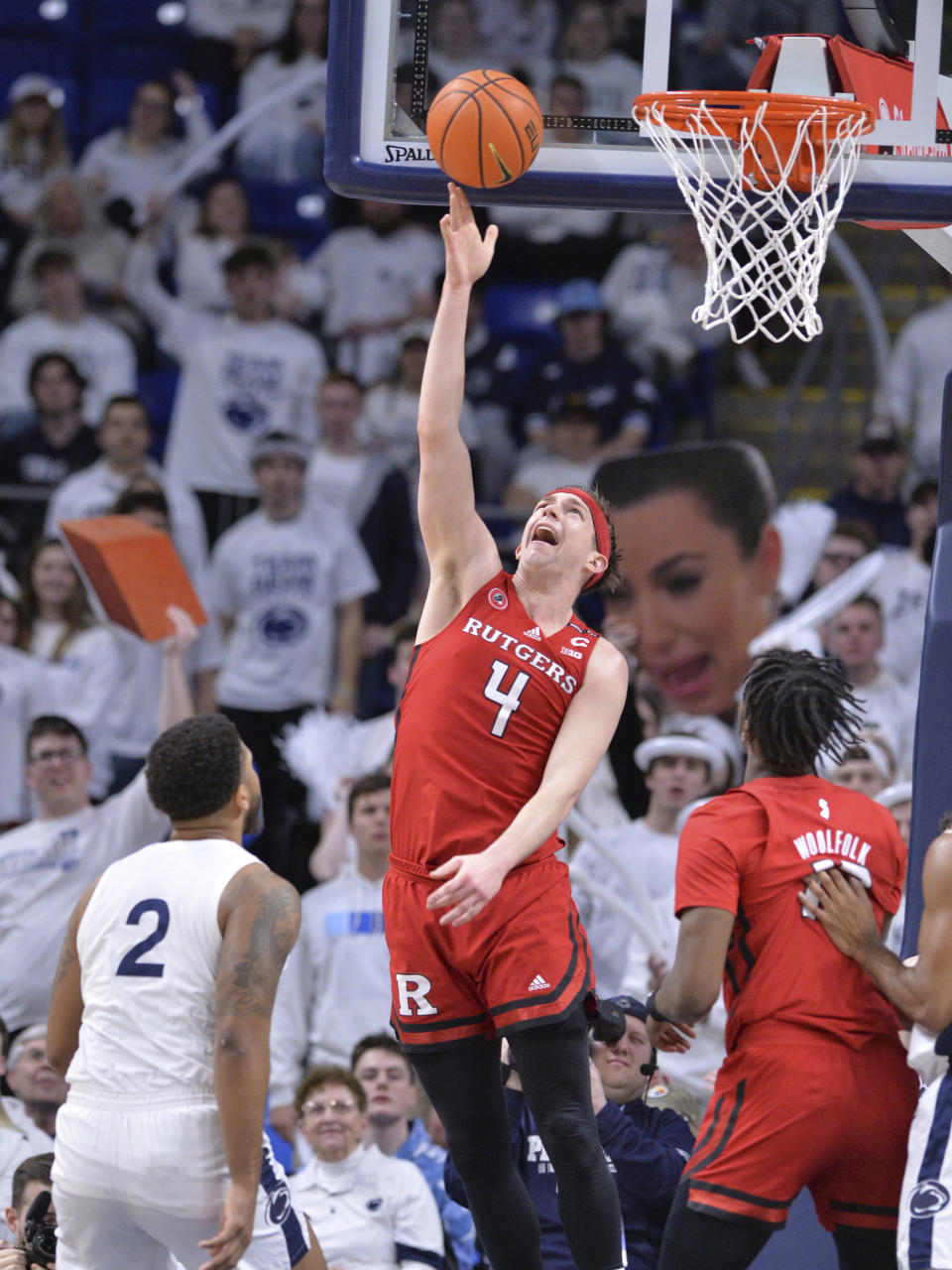 Rutgers' Paul Mulcahy (4) scores on a reverse layup during the first half of an NCAA college basketball game against Penn State, Sunday, Feb. 26, 2023, in State College, Pa. (AP Photo/Gary M. Baranec)