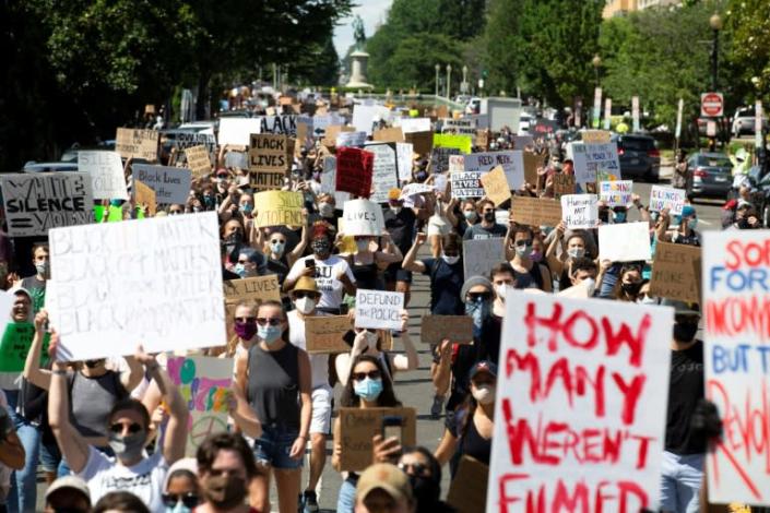 Hundreds of demonstrators walk down 16th Street NW during a rally north of Lafayette Square near the White House to protest police brutality and racism, on June 7, 2020 (AFP Photo/Jose Luis Magana)