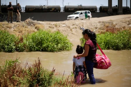 Migrants from Guatemala are seen on the banks of the Rio Bravo river before crossing illegally into the United States as seen from Ciudad Juarez