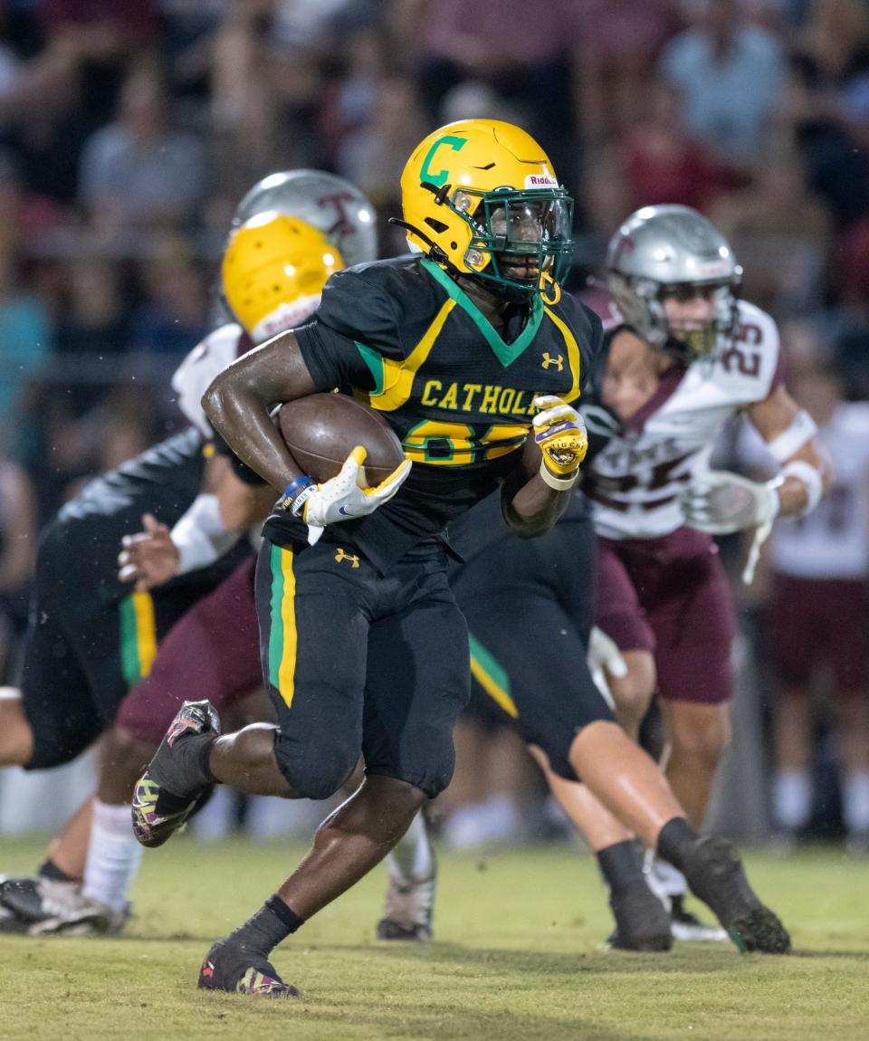 CJ Nettles (25) rushes for a touchdown and a 13-0 Crusaders lead during the Tate vs Catholic varsity Kickoff Classic football game at Pensacola Catholic High School in Pensacola on Friday, Aug. 19, 2022.