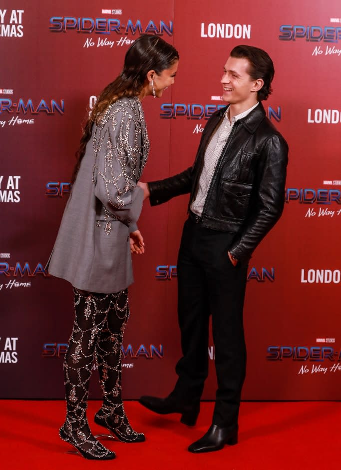 Stylish couple, Zendaya and Tom Holland, share a sweet moment on the red carpet. - Credit: Splash