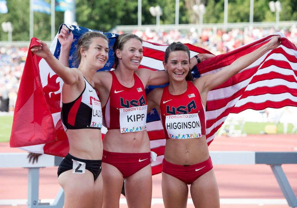 Bronze medal winner Geneviève Lalonde, of Canada, left to right, silver medal Shalaya Kipp, of the USA, and Ashley Higginson, gold medal winner pose for photos after running in the women's 3000m steeplechase final during the athletics competition at the 2015 Pan Am Games in Toronto.