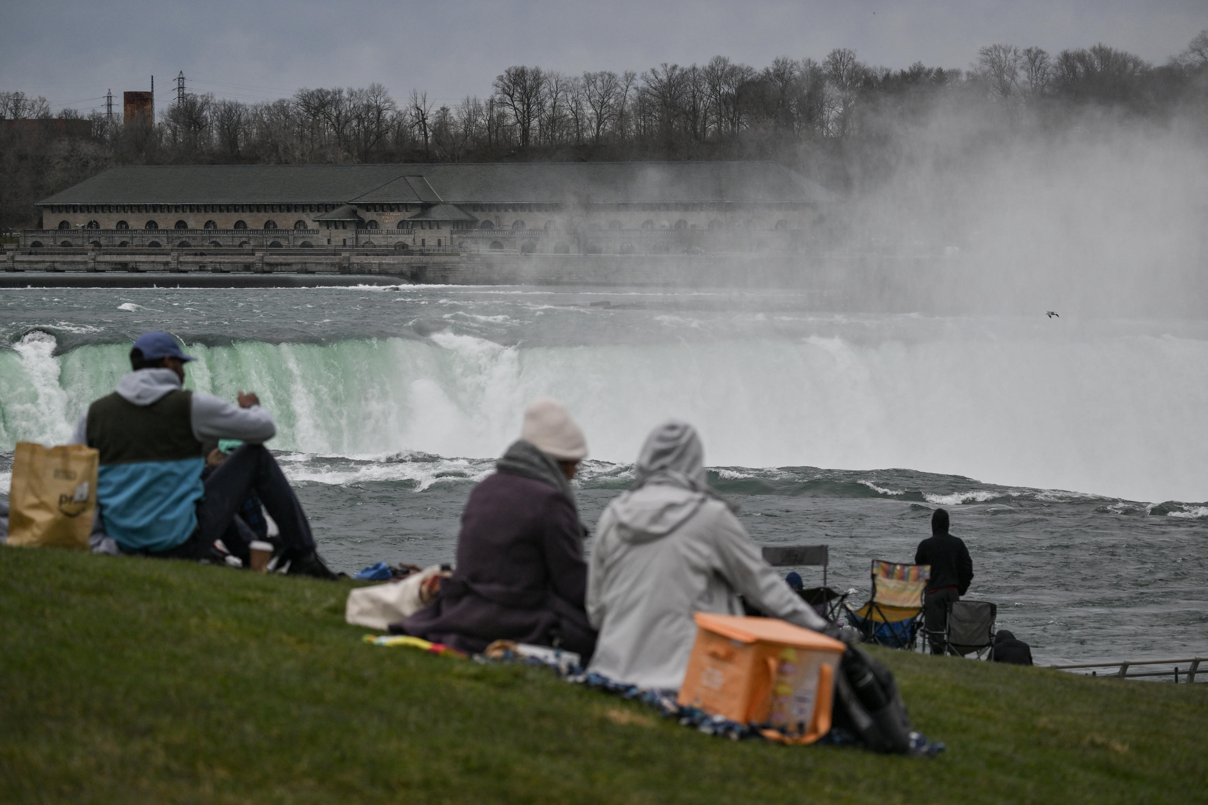 People are set up at Niagara Falls State Park ahead of a total solar eclipse across North America, in Niagara Falls, New York, on April 8, 2024. (Angela Weiss/AFP via Getty Images)