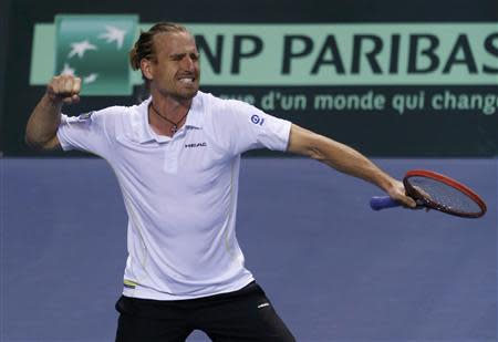 Germany's Peter Gojowczyk celebrates his victory against France's Jo-Wilfried Tsonga during his Davis Cup quarter-final single tennis match in Nancy, Eastern France, April 4, 2014. REUTERS/Vincent Kessler