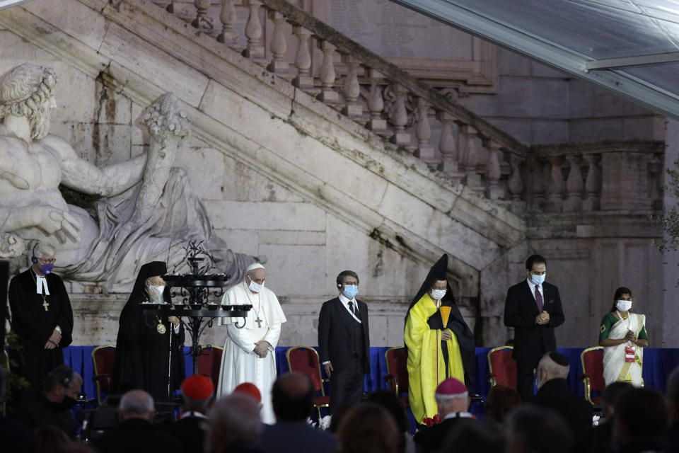 Pope Francis and other representatives of other religions honor the victims of COVID-19 pandemic with a minute of silence during an inter-religious ceremony for peace in the square outside Rome's City Hall, Tuesday, Oct. 20, 2020 (AP Photo/Gregorio Borgia)