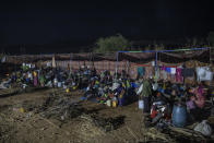 Tigray people who fled the conflict in Ethiopia's Tigray region, gather in their shelters at Umm Rakouba refugee camp in Qadarif, eastern Sudan, Thursday, Nov. 26, 2020. Ethiopia's prime minister said Thursday the army has been ordered to move on the embattled Tigray regional capital after his 72-hour ultimatum ended for Tigray leaders to surrender, and he warned the city's half-million residents to stay indoors and disarm. (AP Photo/Nariman El-Mofty)