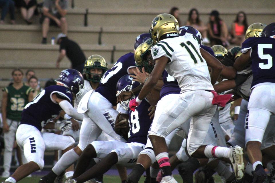 Fletcher quarterback Marcelis Tate (18) pushes the pile on a sneak against Nease in October 2021.