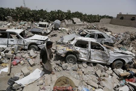 A man walks at the site of a Saudi-led air strike that hit a residential area last month near Sanaa airport, May 18, 2015. REUTERS/Khaled Abdullah