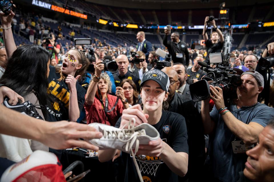 Iowa Hawkeyes guard Caitlin Clark (22) signs autographs after beating LSU in the Elite 8 round of the NCAA Women's Basketball Tournament between Iowa and LSU at MVP Arena, Monday, April 1, 2024 in Albany, N.Y.