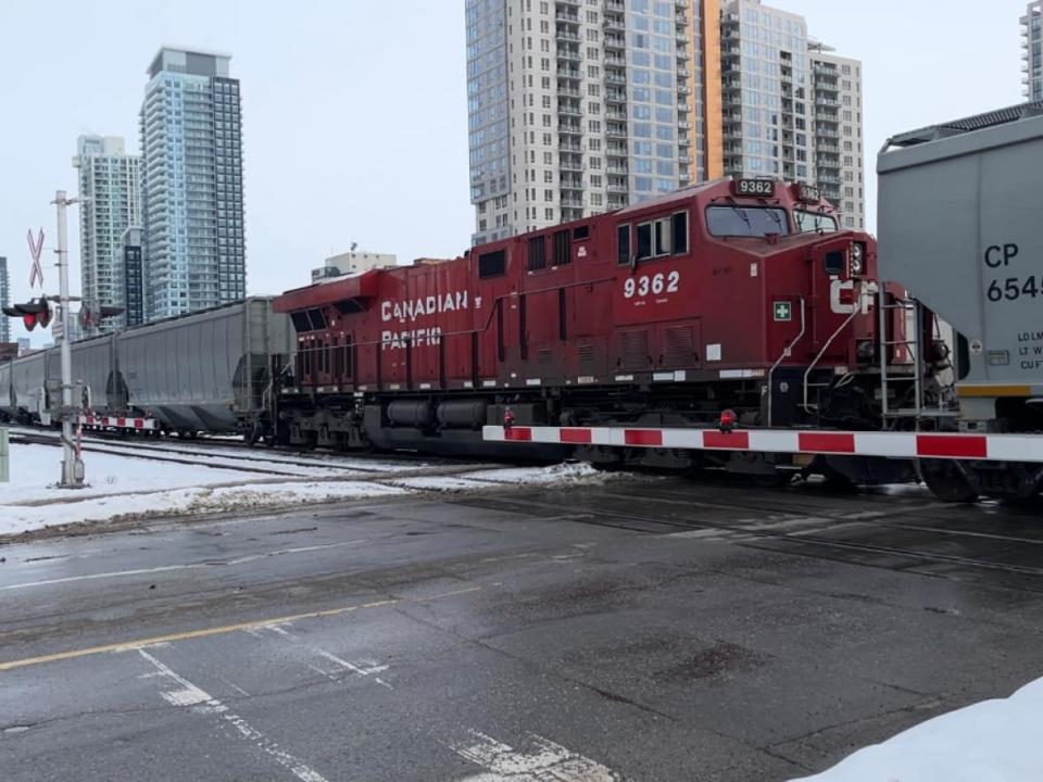 A CP Rail freight train rolls through downtown Calgary. The company says it has led the industry with the lowest train accident frequency rate in North America for 17 straight years. (Bryan Labby/CBC - image credit)