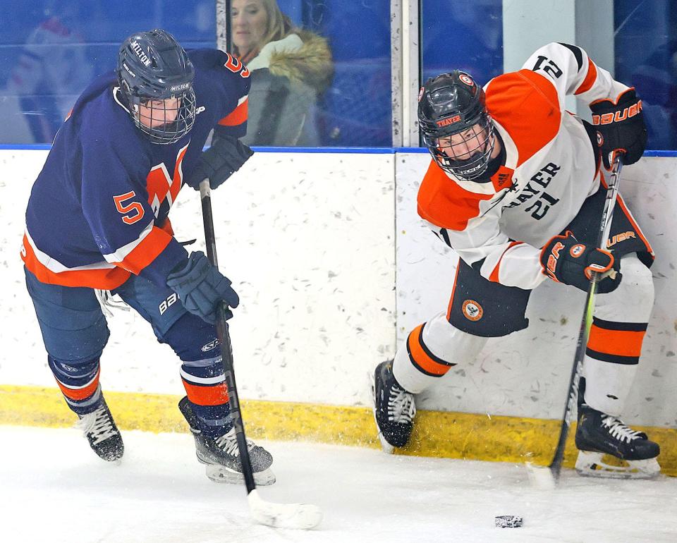 Milton's Nick Brandano, of Lynnfield, left, and Thayer's Mason Shea, of Braintree, battle for the puck during a boys hockey game between Milton Academy and Thayer Academy on Friday, Feb. 16, 2024.