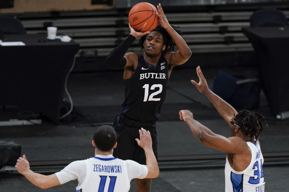 Butler's Myles Tate (12) shoots over Creighton's Denzel Mahoney (34) and Marcus Zegarowski (11) during the first half of an NCAA college basketball game in the Big East conference tournament Thursday, March 11, 2021, in New York. (AP Photo/Frank Franklin II)