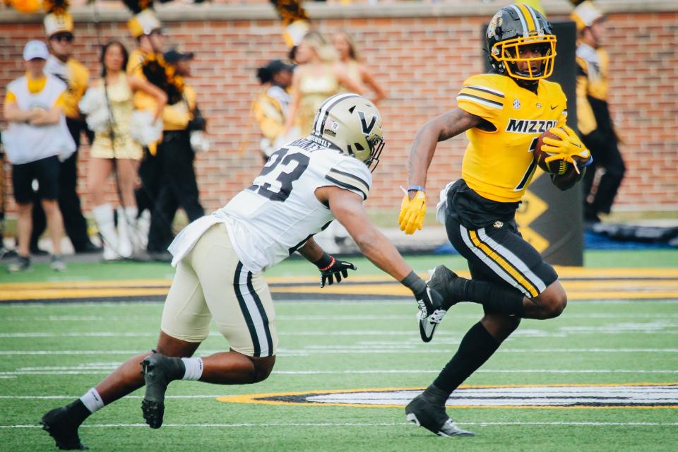 Missouri wide receiver Dominic Lovett (7) tries to evade a Commodore defender during the Tigers' homecoming game against Vanderbilt on Oct. 22, 2022.